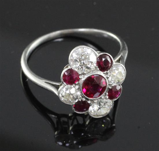 An attractive early 20th century platinum, ruby and diamond cluster ring, size Q